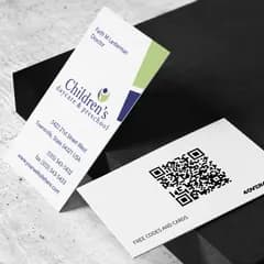 Children's daycare free business card front and QR code back on a stone surface